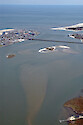 Aerial view of the Ocean City Inlet from Isle of Wight Bay. Also visible are Skimmer Island, the northern end of Assateague Island, and the Route 50 bridge.