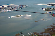 Aerial view of the Ocean City Inlet from Isle of Wight Bay. Also visible are Skimmer Island, the northern end of Assateague Island, and the Route 50 bridge.
