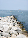 Fishing is popular at the Chesapeake Bay Bridge Tunnel. Fishing boats are positioned just to the left of the tunnel, which emerges on the rock island in the background.