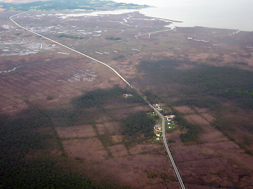 Looking west alone Route 363, Deal Island Road. Mongrel Neck and Saint Peters Marsh are situated between the road and Monie Bay to the north. Pigeonhouse Creek and then Dames Quarter Creek can be seen in the background.