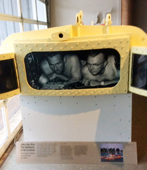 The Aquascope at the Calvert Maritime Museum with a photograph of Gilbert Klingel (left) and Willard Culver (right) peering out the viewing windows.