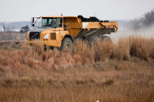 A dump truck moves around material on Poplar Island. (Photo: Chesapeake Bay Program)