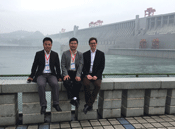 Simon and Chinese hosts pose in front of the Three Gorges Dam