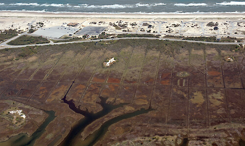 Mosquito ditches and marshes on the inland side of Assateague Island, bordering Sinepuxent Bay.