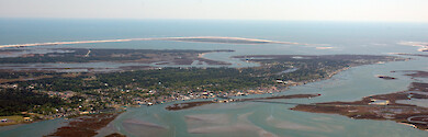 Chincoteague Island in Chincoteague Bay. Visible in the background are Assateague Island and the Chincoteague Inlet.