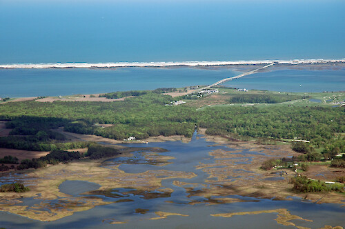 Eroding marshes in Newport Bay, with Sinepuxent Bay and Assateague Island in the background.