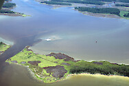 This photo shows multi-hued water plumes in Charles Creek and Honga River around The Canal separating Wroten Island (left) from Parks Neck (right). Widgeon grass (Ruppia maritima) meadows are also visible throughout.