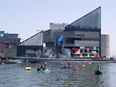 Families enjoying Baltimore Harbor with the aquarium in the background