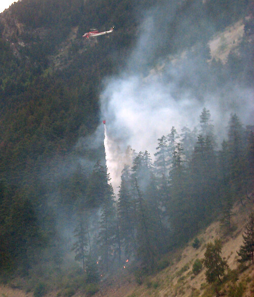 Water bombing by helicopter is often used to fight forest fires