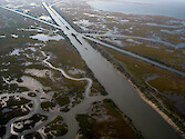 Navigation channel disecting eroding marsh in coastal Louisiana
