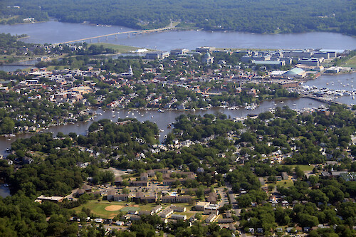 Eastport (foreground), Annapolis, and the US Naval Academy. Spa Creek is in the foreground, and the Severn River and Route 450/Naval Academy bridge are in the background.