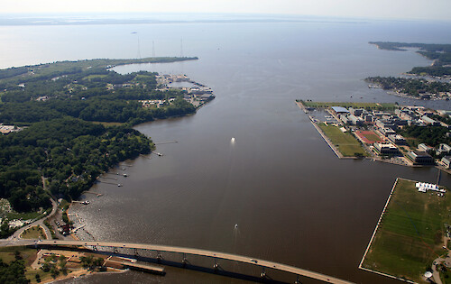 The mouth of the Severn River, leading into Chesapeake Bay. The Route 450 bridge is in the foreground, the US Naval Academy is visible on the right, and Kent Island is in the background.
