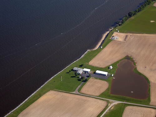 Farm on the edge of northern Chesapeake Bay, with little vegetation buffer and riprap shoreline