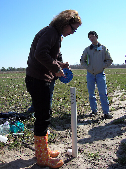 Demonstrating how water quality measurements are taken in a field in Maryland. 