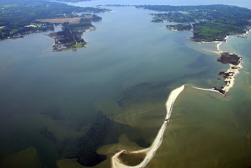 Looking northwest over Sandy Point on Gwynns Island, Virginia. Seagrass (submerged aquatic vegetation) is visible behind the sand shoals