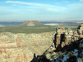 Desert View lookout on the South Rim of the Grand Canyon. Navajo Nation lands and Painted Desert in the background.
