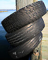 Tires around a piling on the dock at Horn Point Lab, used as bumpers for docking boats