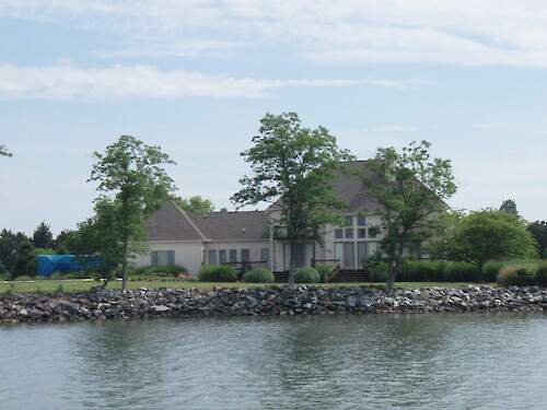 This is an example of a hardended shoreline with residential development very close to the water. As an example, this type of development is often on septic systems which can leach and input nutrients into the nearby waters.
