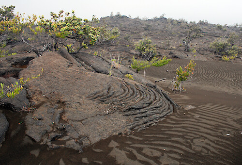 pahoehoe lava, also called rope lava, drapes over lava sand desert on Ka'u Desert Trail