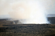 A crator from the volcano Kileaua Caldera in Hawaii emits sulfer dioxide, gas, and steam