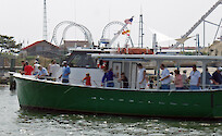 A group of people fishing off of a boat in the Ocean City's Southern Harbor.