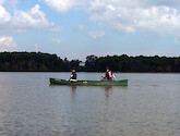 Two canoers on the Jug Bay look towards the shore. The Jug Bay Wetlands Sanctuary is a part of the National Estuarine Research Reserve, and is located in Maryland, USA.