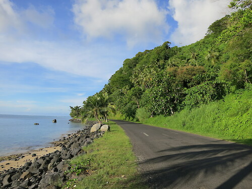 Coastal road and seawall to the northeast of Apia, Samoa.