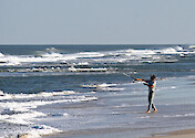 Casting into the Atlantic Ocean, the fisherman tries his luck for any sportfish that comes along. Assateague Island National Seashore, Maryland.