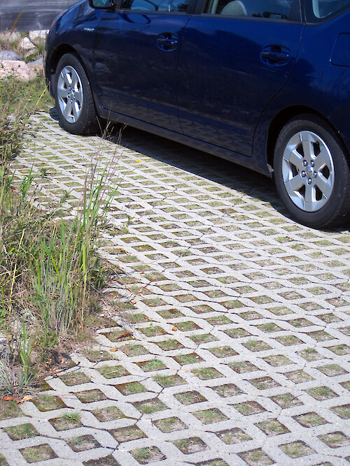 Permeable pavers are brick-like materials that are manufactured in a variety of shapes. Pavers fit together like tiles and are set with small gaps between them, creating grooves for water to infiltrate the soil beneath. Permeable pavers reduce stormwater runoff volume and flow rate, and increase groundwater infiltration and recharge.