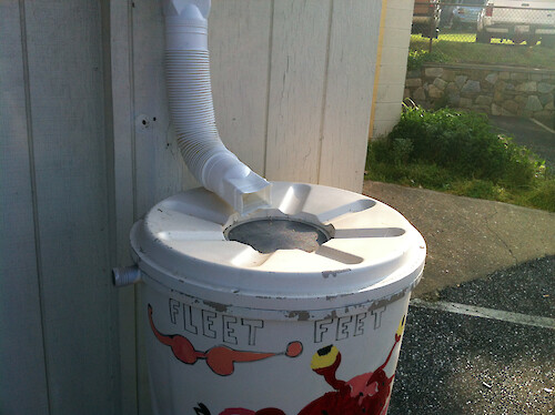 Rain barrel with downspout in Fleet Street, Eastport, Annapolis in Maryland.