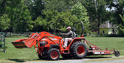 Landowner driving a tractor on his farm on the Eastern Shore of Maryland.