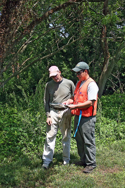 Chesapeake Watershed Forester and landowner discuss best management practice options, on an Eastern Shore Maryland farm.