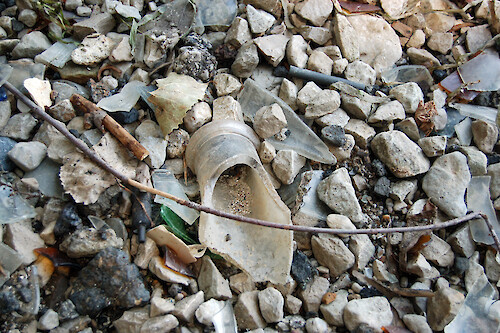 Trash has built up over time on the shoreline of the Pipe Creek Wildlife Area. This trash comes from people throwing it off of boats as well as people leaving it on the small beach. Sandusky, Ohio.