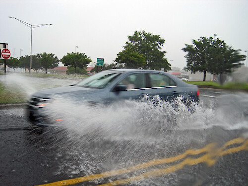 Car driving through flooding waters in Maryland.