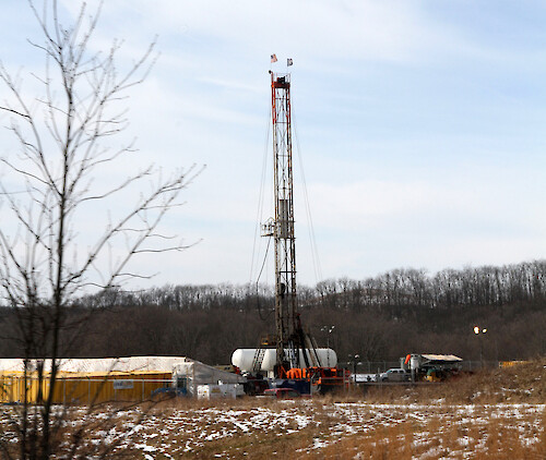A small well located in Scio, Ohio used for hydraulic fracturing. The tower is the drill used to make the hole which will later be used to shoot liquid down to fracture the rock and extract the petroleum products. Sometime these areas are called Well Pads.