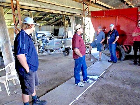 Phil Trendell, Reef Catchments and Neil Walpole in Neil's shed with the 'tinny' in the background.