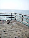 Idle fishing rods lie along the fishing pier at the Chesapeake Bay Bridge Tunnel