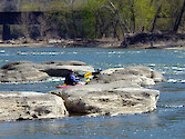 Kayakers recreate among rocks near the confluence of the Shenandoah and Potomac Rivers at Harper's Ferry, West Virginia 
