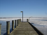 The Horn Point Laboratory dock, on Maryland's Eastern Shore, juts out into a frozen Choptank River.