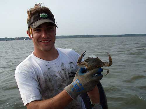 David holds a frothing blue crab found in a ghost crab pot. 