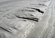 Rivulets carved by water in the sand at a beach by Charleston, South Carolina