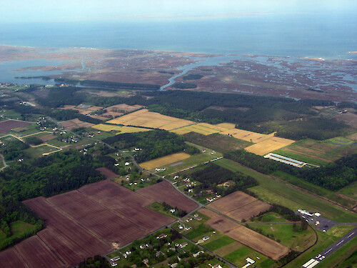 Suburbs, agriculture, and wetlands lined up next to each other near Crisfield, MD.