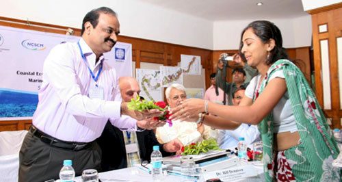 Dr. Ramesh receiving a bouquet of flowers
