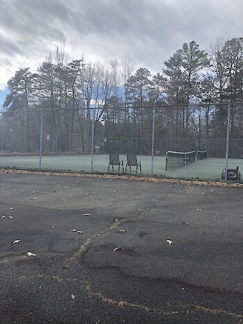 a vacant but well-maintained tennis court