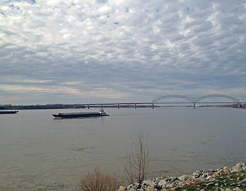 Barge traffic on the Mississippi River viewed from Memphis, TN. Arkansas is on the other side of the river.