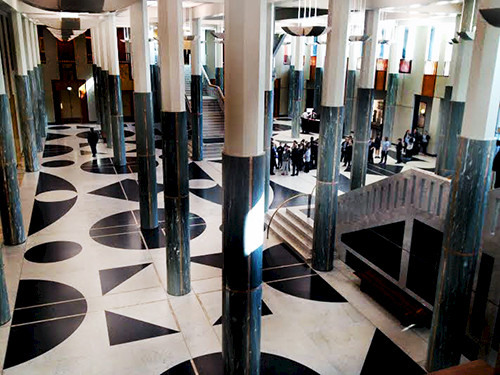 Lobby of Australian Parliament House with pillars emulating gum tree trunks.