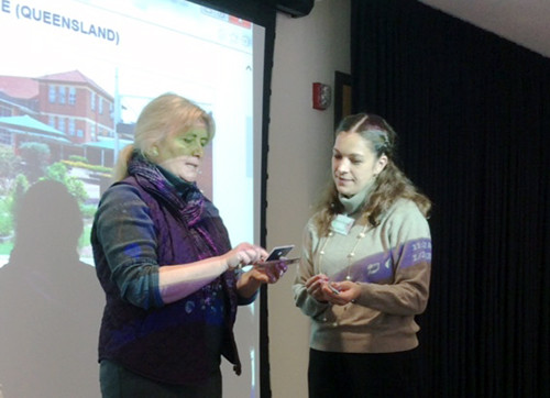 Judy O'Neil and Amanda Pierman performing gift exchange between partner schools.