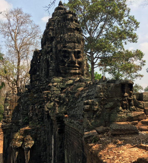 Buddha head carved into the walls of the Bayon temple inside Angkor Thom
