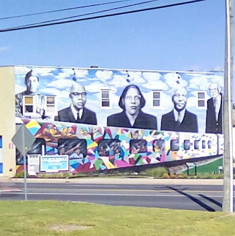 A building mural of prominent and historical African American figures.