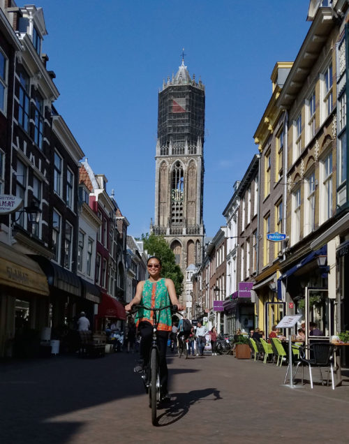 Riding my bike around Utrecht, with the Dom Tower in the background. Photo by Thong Nguyen.